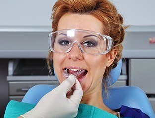 woman putting in oral appliance
