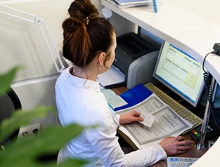 a front desk worker inputting information into a computer