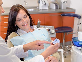 dentist pointing to replica