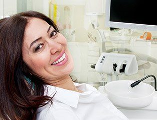 woman in white smiling at camera