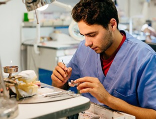 Dental lab technician crafting a dental crown