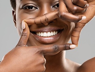 Woman outlining her smile with her hands