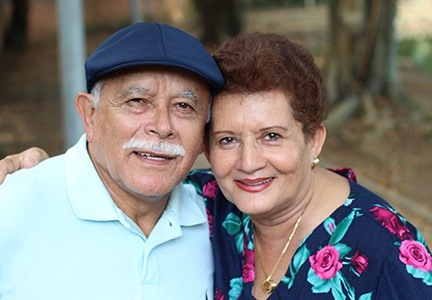 husband and wife hugging and smiling