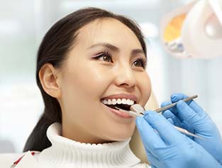Woman smiling during routine dental checkup