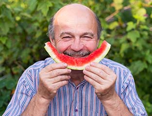 Smiling man with watermelon