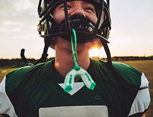 Football player with mouthguard to prevent dental emergencies