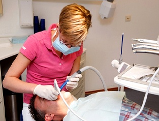 dental hygienist cleaning teeth