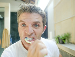 Man brushing dental implants in Greenfield