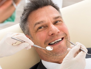 Man smiling at dentist in Greenfield