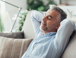 a man relaxing and resting on his couch