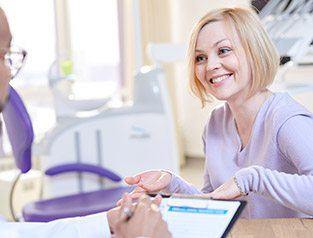 A patient smiling at a dentist