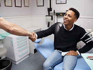 A patient shaking hands with a dentist