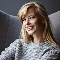 woman smiling in grey chair