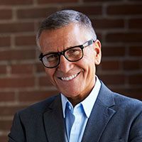 man in suit and glasses smiling