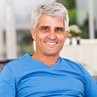 man with grey hair smiling