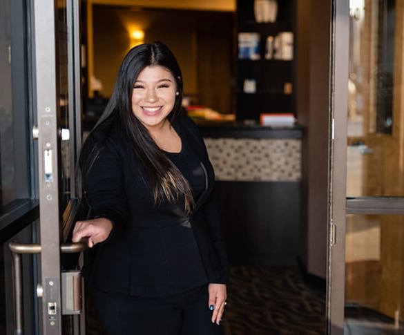 team member opening the door to red carpet