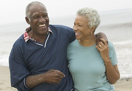 man and woman at beach laughing