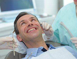 man smiling up at dentist