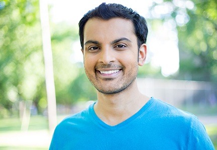 man in blue shirt smiling