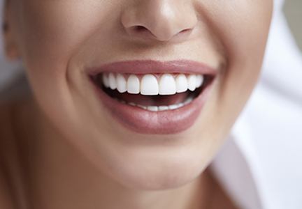 woman with hoop earrings smiling