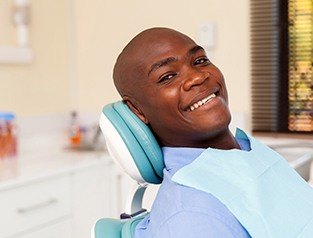 man laying back in exam chair