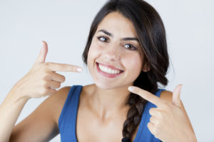 Woman pointing to smile