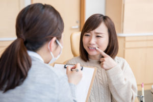 Woman suffering from gum disease