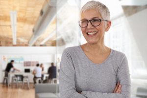 older woman smiling with dentures in Greenfield