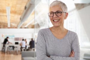 older woman smiling with dentures in Greenfield 