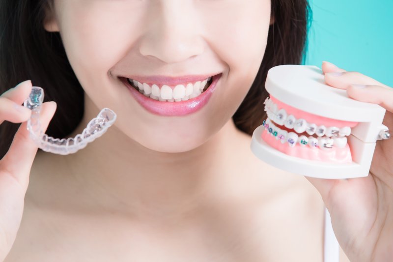 Woman comparing Invisalign vs. braces in Greenfield