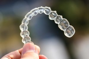 Closeup of Invisalign in Greenfield on a colorful background