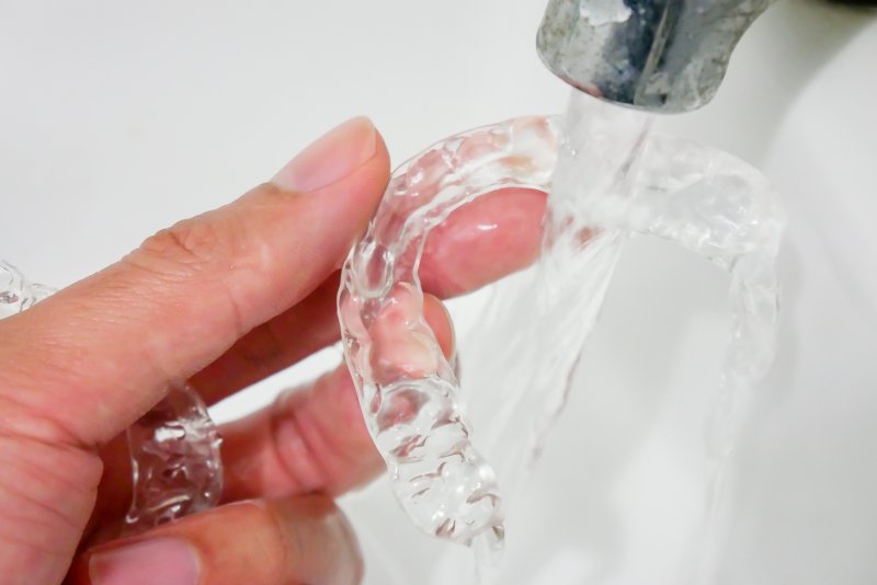 cleaning Invisalign aligner with running water