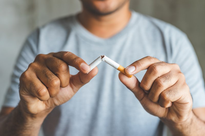 man breaking cigarette