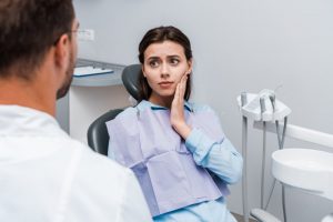 Woman at dentist with toothache 