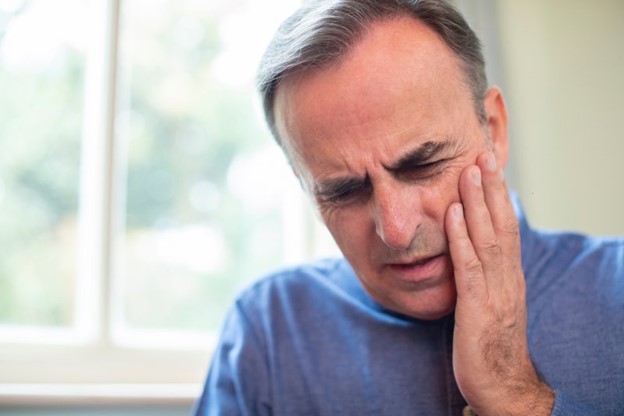 Man experiencing extreme mouth pain.