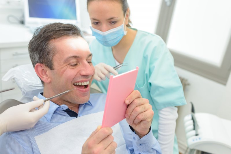 patient smiling after getting dental crown in Greenfield