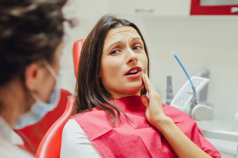 woman visiting emergency dentist in Greenfield 
