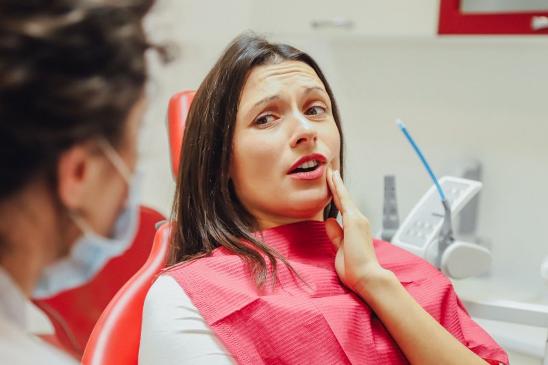 woman visiting emergency dentist in Greenfield