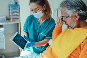 an older patient visiting their dentist