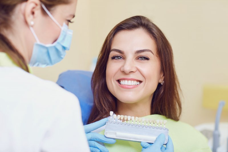 Woman smiles in dentist's chair.