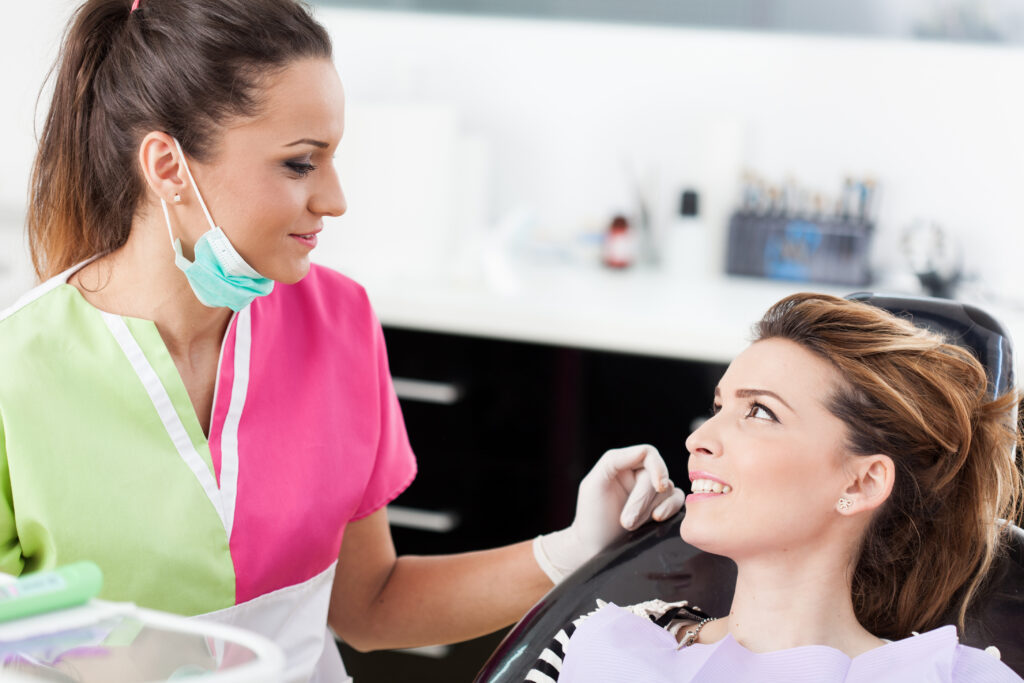 Dentist helping a patient