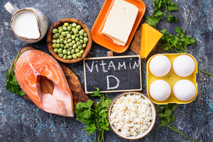 Chalkboard surrounded by fish and other foods containing vitamin D