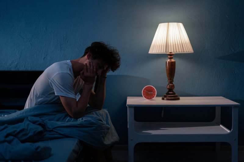 A sleepless man suffering from sleep apnea